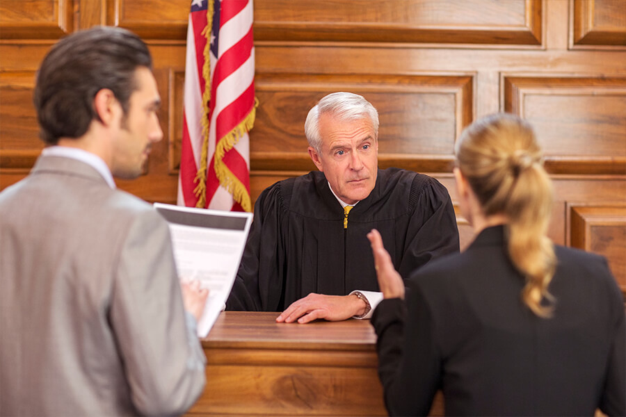 courtroom judge with two lawyers